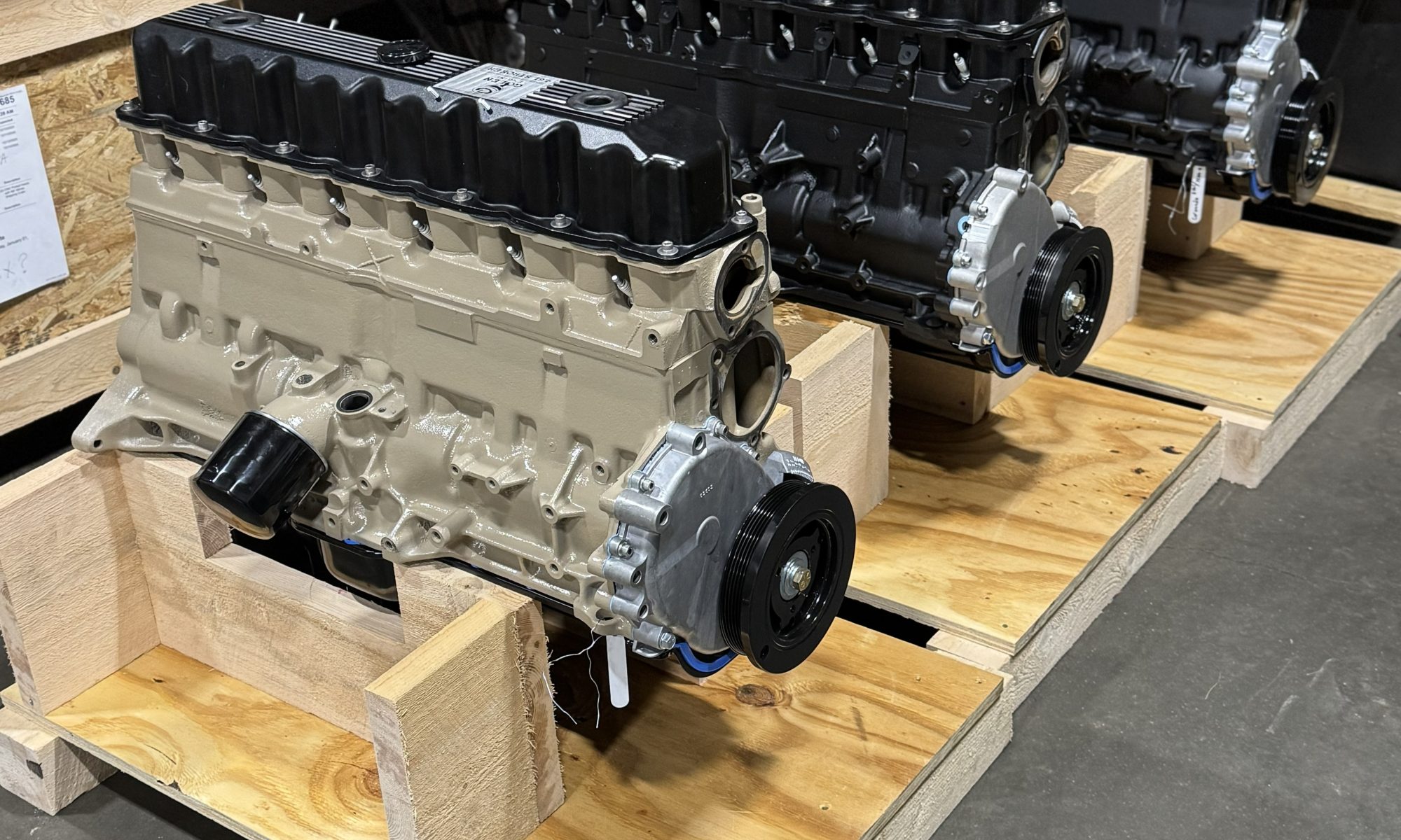 Row of freshly built Jeep 4.0 inline‑six crate engines on wooden pallets in a warehouse, ready for reliable installation and trail duty.