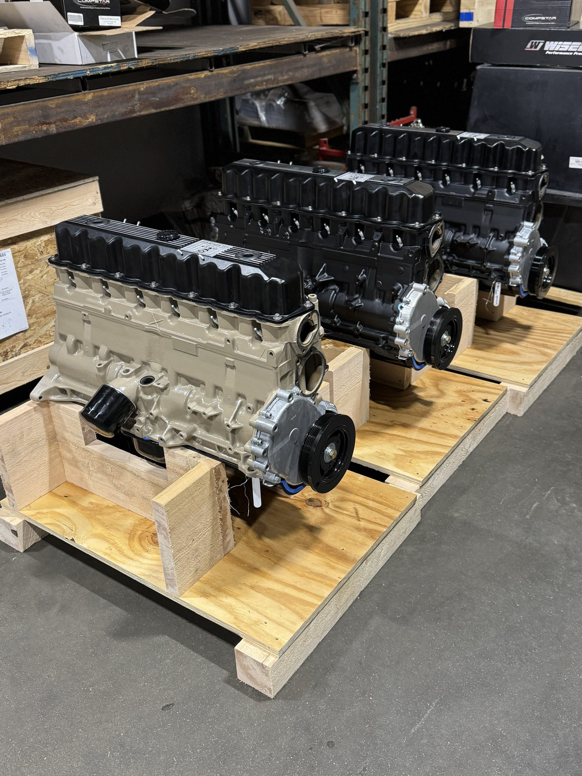 Row of freshly built Jeep 4.0 inline‑six crate engines on wooden pallets in a warehouse, ready for reliable installation and trail duty.